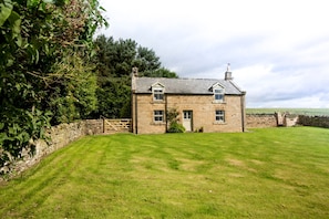 Enclosed, walled garden. Shortflatt Farm Cottage, a detached former farmhouse.