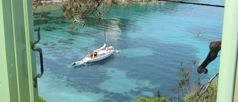 The turquoise-blue  sea waters in front from the bedroom 1, windows