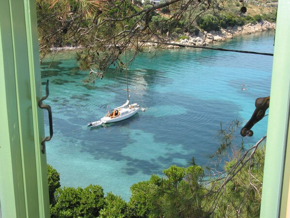 The turquoise-blue  sea waters in front from the bedroom 1, windows