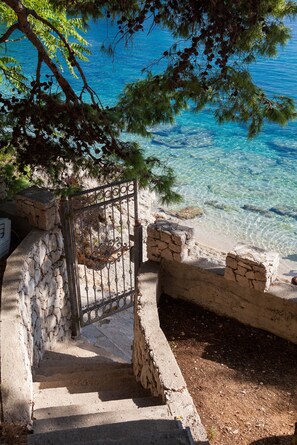 Private steps leading to the azure sea