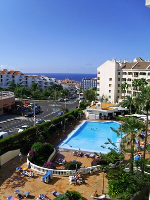 View of pool and sea from balcony.