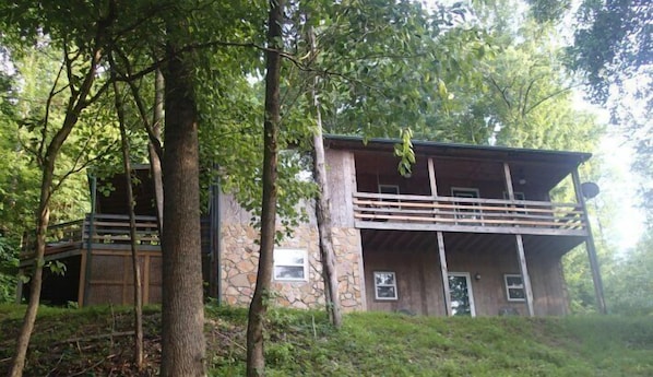 Front of home  that faces lake, side deck off of master bedroom with hot tub.