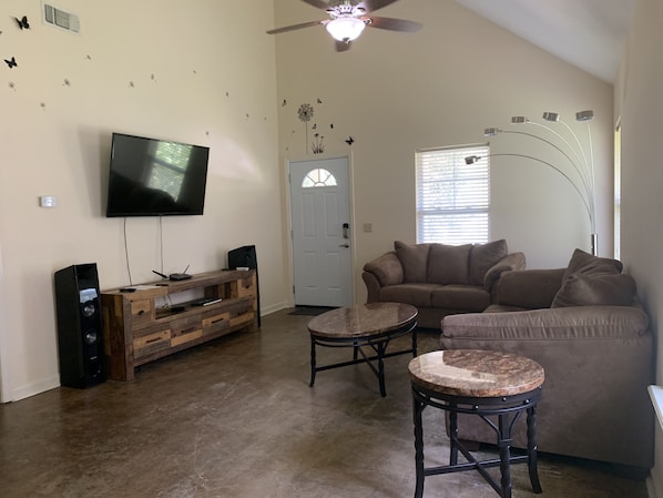 Living room with 55 inch TV connected to Apple TV and two Samsung stereo speaker