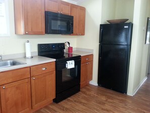 A new kitchen with full size appliances.