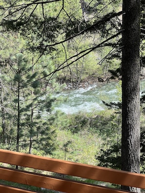The deck has four comfy patio chairs and a large table for eating outside.