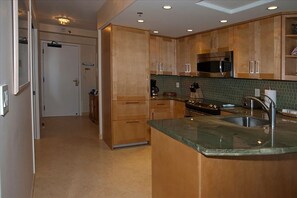 Looking in from living area toward kitchen and front door.