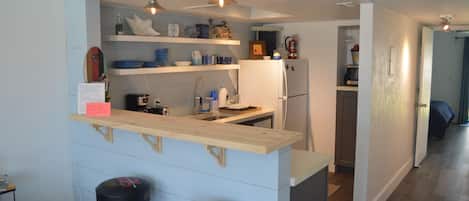 Remodeled kitchen with concrete countertops, deep sink and great lighting