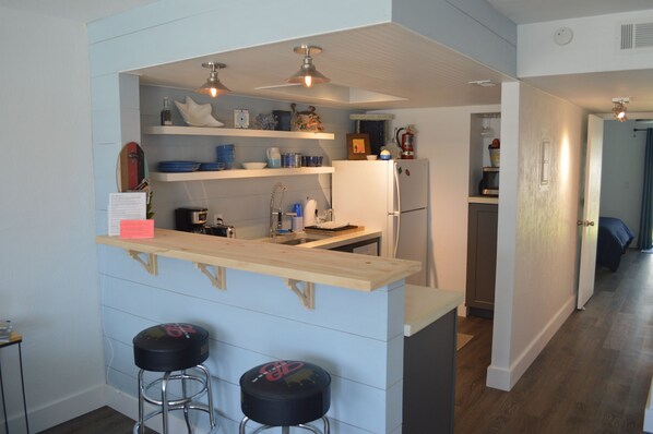 Remodeled kitchen with concrete countertops, deep sink and great lighting