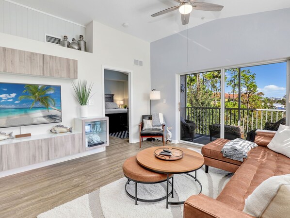 Living Room with Leather Sectional for viewing the 55" Smart TV & screened patio
