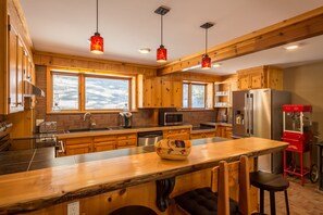 Kitchen with forest views out of eye level windows keeping you in nature.