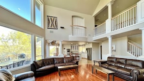 Spacious, open floor plan with many windows in the living room of the main house