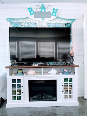 Beautiful beachy decor sunroom with 65 inch Smart TV Wi-Fi and cable included