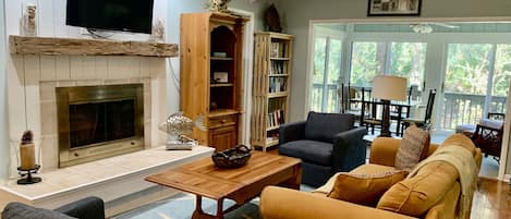 Bright living room and sunroom create a great main living space in this cottage.