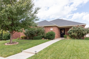 Front of house with manicured landscape