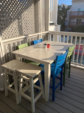 Table and 6 chairs for eating outside in screened in porch.