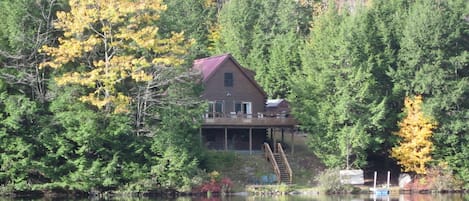 View of cabin from lake in October