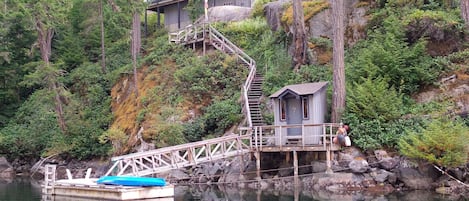 A view of the cottage and private dock from the water