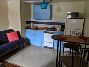 Full urban kitchen: gas range, oven, microwave and full size refrigerator.