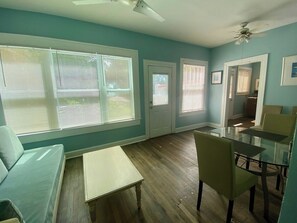 View of the living/dining area from the doorway of the bedroom, kitchen is through the doorway to the right. 