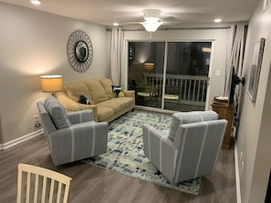 Living Room, exits to Balcony with stairway down to pool