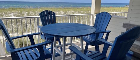 Gulf front relaxing and dining - A Polywood dining table and chairs provides a prime space for dining overlooking the emerald green Gulf of Mexico waters.