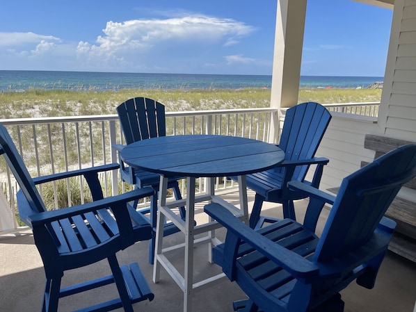 Gulf front relaxing and dining - A Polywood dining table and chairs provides a prime space for dining overlooking the emerald green Gulf of Mexico waters.