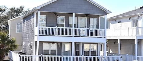 Front of house w/ huge 1st level deck and 2nd level balcony