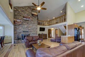 View of fireplace and railing around upper level of home