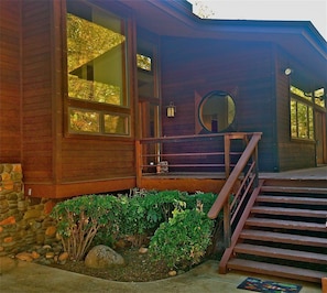 Main entrance with custom moon window. Huge front deck looking out to Red Rocks.