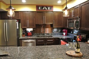 Newly remodeled kitchen with granite, stainless appliances, new sink & lighting.  