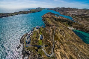 The lighthouse roadway undulating through gorse and heather to the property