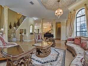 Formal living area with custom ceilings & lighting