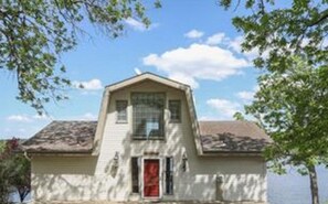A Large Concrete Driveway and Porch provide plenty of parking and outside space