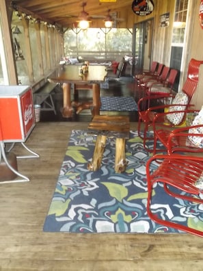 Large screened porch with sitting areas and 8 person eating table.