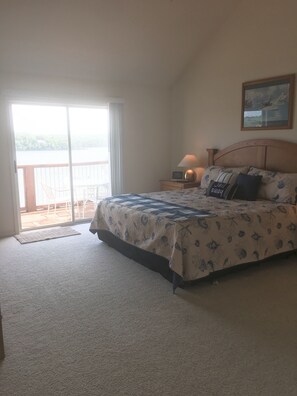 Master bedroom with private bath and sliding doors leading out to deck