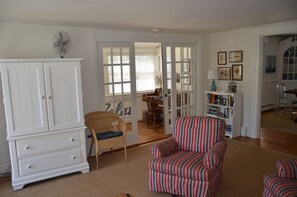 Living Room with a view into the enclosed porch