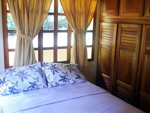 Guest cottage bedroom with queen bed and built-in closets.