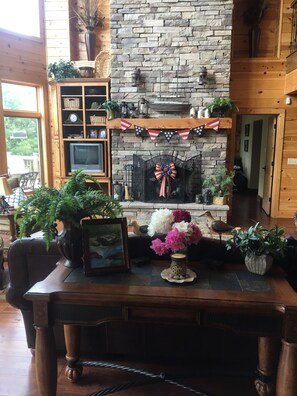 Main living overlooks lake with ample seating and gorgeous 30ft fireplace 