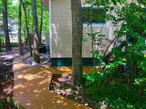 Boardwalk connects driveway w/both front entrances & the outside shower/BBQ area