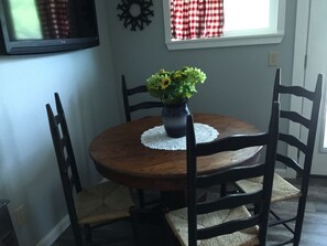 Dining room. There is a bench to seat more. Picnic table, and grill outside.