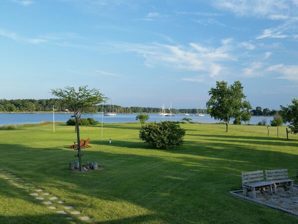 Backyard view from the deck. Fire pit on the right side of the photo