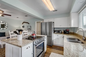 Fully Equipped Kitchen with Granite Countertops, Stainless Steel Appliances, and Bar Seating for 2