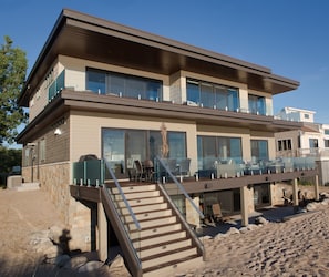 Front of house facing lake Mich.  Upper deck, main deck & lower patio w/ shower