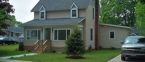 House with enclosed front porch, nice back yard and rear deck.