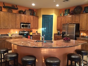 Modern kitchen with stainless steel appliances, granite counter that seats 6..