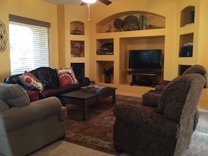Great room in open concept home with comfortable seating overlooking the patio. 