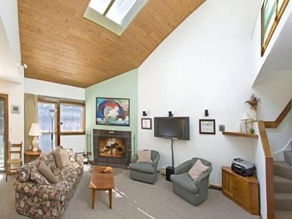 living room with lofted ceilings bright and cheery feel