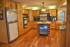 Chef's kitchen w/ Heartland appliances, butcher board island & wine refrigerator