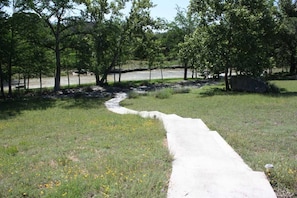 Behind the house, your path to Bandera Creek is clearly marked. Keep in mind the creek levels are seasonal, check with us for water depth when you book.