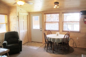 Living room and dining area looking toward lake and owner's log home.